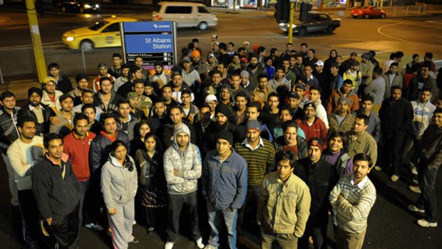 Safety in numbers: Indian students and workers gather outside St Albans station to help late-night commuters avoid attacks. 