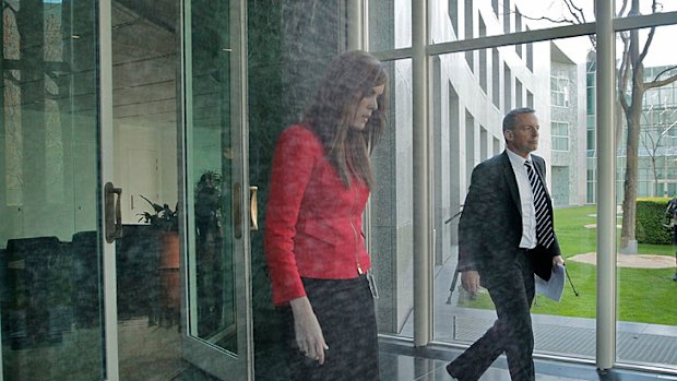 A stony-faced Tony Abbott leaves the Prime Minister's Parliament House office accompanied by his chief of staff Peta Credlin.