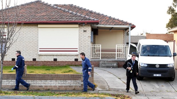 Forensic officers at a home on Edgars Road where a woman's body was found in Lalor.