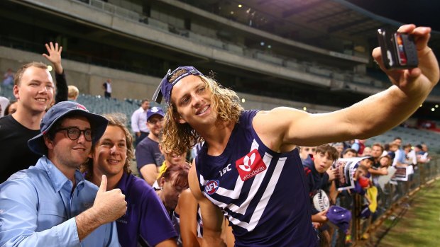 PERTH, AUSTRALIA - MARCH 10: Nathan Fyfe of the Dockers poses for a selfie with spectators after winning the JLT Community Series AFL match between the Fremantle Dockers and the Carlton Blues at Domain Stadium on March 10, 2017 in Perth, Australia. (Photo by Paul Kane/Getty Images)