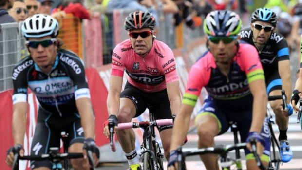 Cadel Evans (centre) crosses the finish line of the ninth stage of the Giro d'Italia on Sunday.