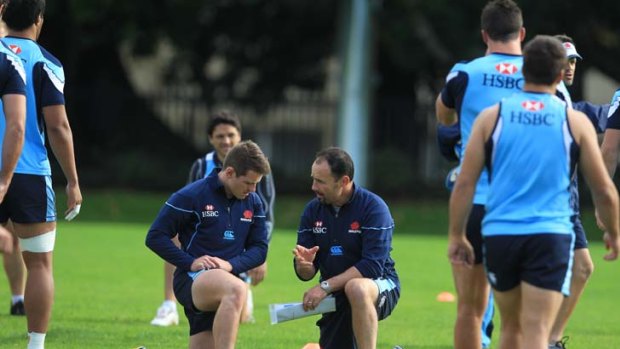 Foley on Foley &#8230; Bernard Foley, left, gets attention from Waratahs coach Michael Foley, who is juggling positions to use his top talent against the brumbies.