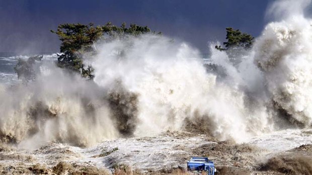 This picture taken on March 11 shows tsunami waves hitting the coast of Minamisoma in Fukushima prefecture.