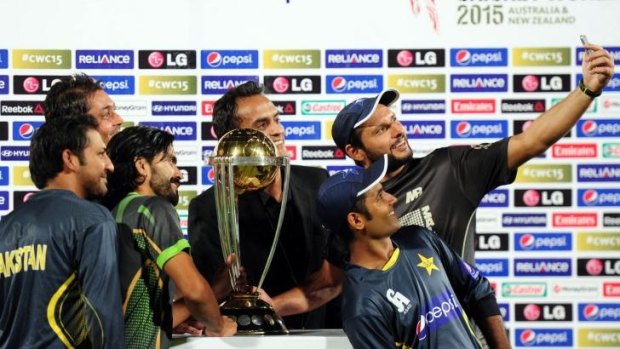 Shahid Afridi (right) takes a selfie with teammates with the ICC World Cup 2015 trophy during a ceremony in Karachi.