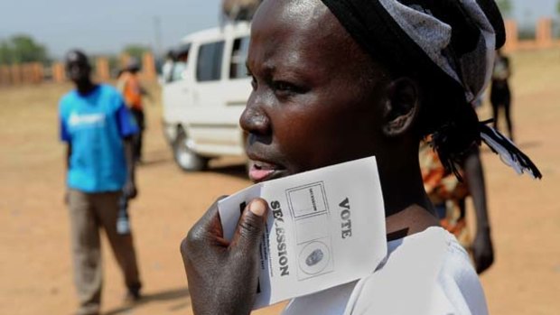 A woman holds a ballot paper to be used in the referendum.