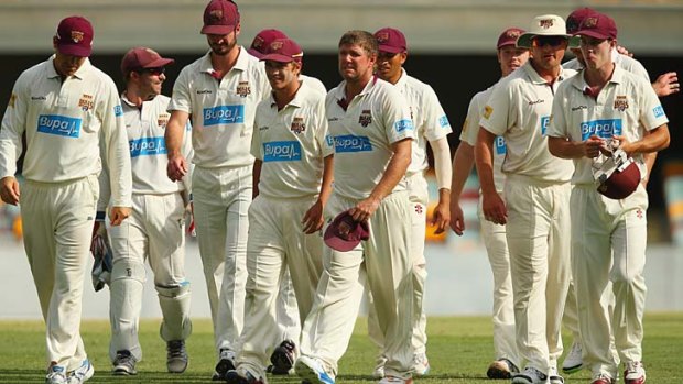Queeensland skipper James Hopes leads his team off after defeating Victoria by 181 runs at the Gabba.