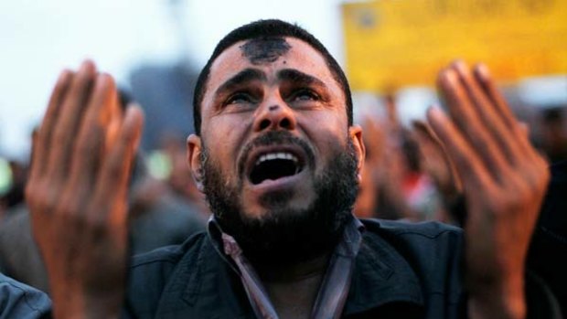 An Egyptian protester cries during prayers in Tahrir Square in Cairo.