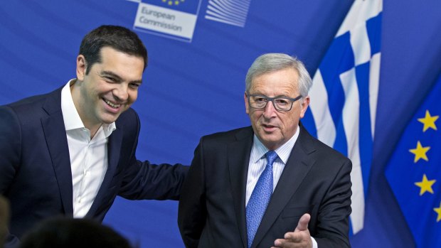 Greek Prime Minister Alexis Tsipras (left) is welcomed by European Commission President Jean Claude Juncker (right) for a meeting ahead of a Eurozone emergency summit in Brussels.