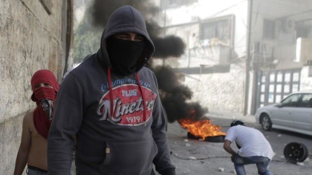Flashpoint: Masked Palestinian youths clash with Israeli security forces in East Jerusalem.