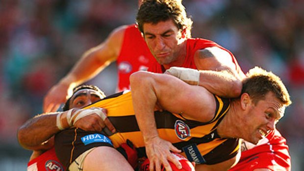 Brett Kirk and Adam Goodes are not letting Sam Mitchell get away.