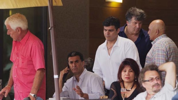 Coffee time &#8230; convicted Kings Cross drug supplier Bill Bayeh, centre, takes a call at a cafe on Friday, seven months after his release from prison.