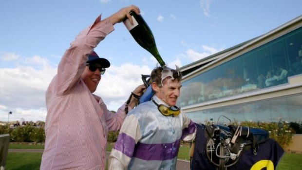 Congratulations: Robert Thompson is doused in champagne by his friend, Jeremy Sylvester, after his 4000th race win.