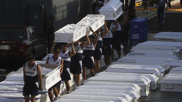 Hundreds of coffins, donated by the Philippines navy, wait on the Manila docks to be shipped to storm-stricken Cagayan de Oro for mass burials.