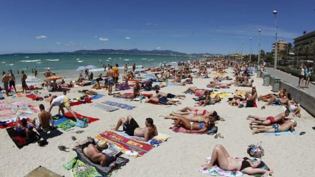 Tourists crowd Palma de Majorca's Arenal beach.
