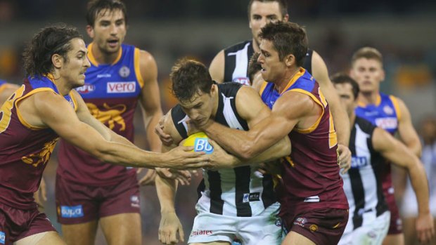 Kyle Martin of the Magpies is tackled by Simon Black of the Lions during the round ten AFL match between the Brisbane Lions and the Collingwood Magpies at The Gabba on May 31, 2013 in Brisbane.