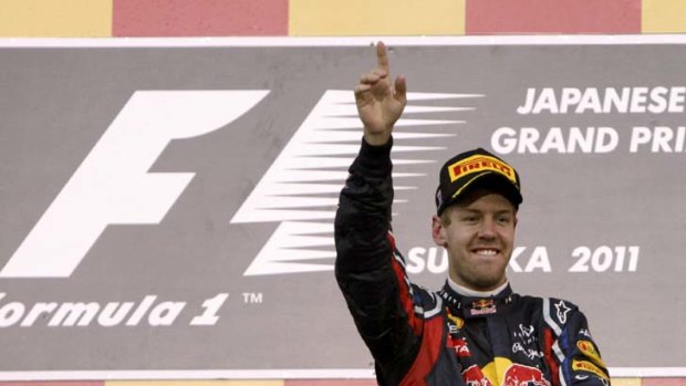 Champion ... Sebastian Vettel marks a third, and a first.