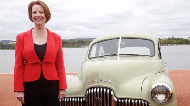Australia's own Prime Minister ... Julia Gillard, like Ben Chifley in 1948, poses with the first Holden off the assembly line.