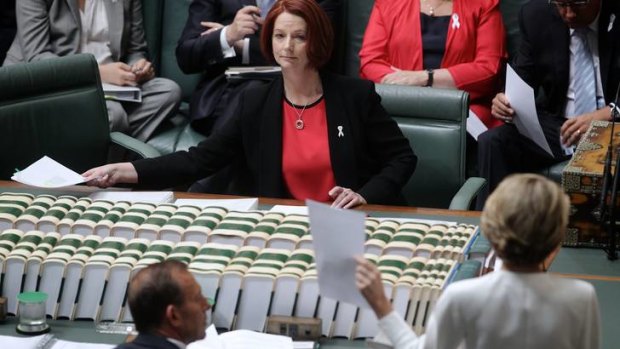 The opposition's deputy leader Julie Bishop shows a document to Prime Minister Julia Gillard during Question Time at Parliament House in Canberra on Monday.