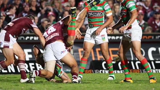 Greg Inglis is on the receiving end of a dangerous tackle from Richie Fa'aoso.