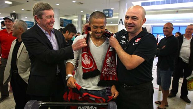 Touchdown ... Western Sydney Wanderers new recruit Shinji Ono receives a warm welcome from club officials at Sydney Airport yesterday.