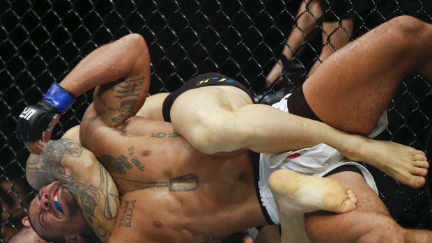Savagery: Gleison Tibau, of Brazil, puts American Abel Trujillo in a choke-hold during a recent UFC bout.
