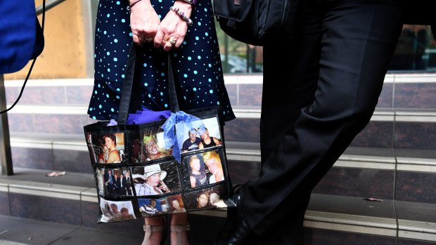 Faye Leveson carries a bag with images of her son as she arrives at the coronial inquest on Tuesday. 