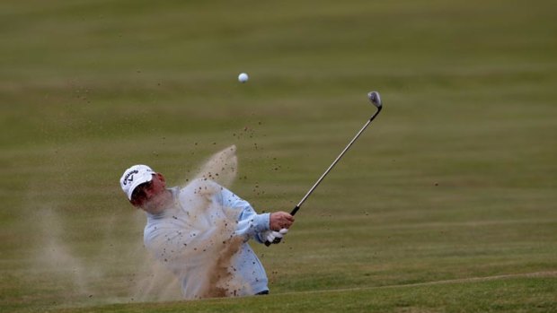 Thomas Bjorn blasts out of a bunker at the British Open.