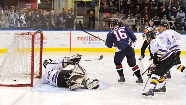 Matt Armstrong dumps in yet another goal in Ice's 9-1 thrashing of the Ice Dogs.