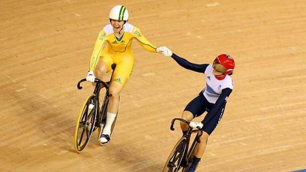 Magic moment ... Britain's Victoria Pendleton raises the arm of Anna Meares after the Australian's gold medal win at the velodrome.