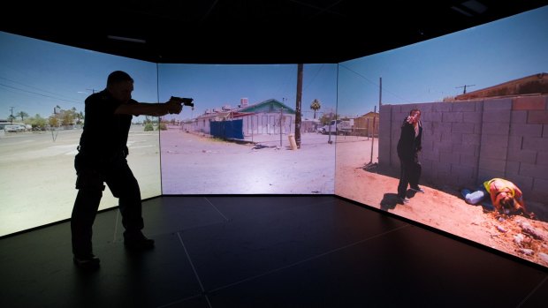 A Victorian policeman using the force's new simulator used for active shooter training.