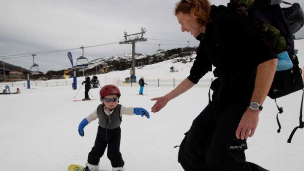 Baby steps ...  Tarn Browning, 2, from Jindabyne snowboards with his father Stuart.