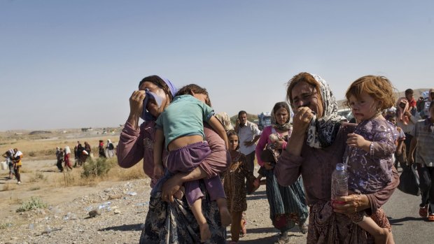 A photo of Iraqi Yazidi people who fled their homes in Sinjar, taken by Adam Ferguson.