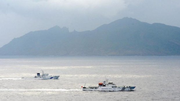 A Japan Coast Guard vessel, left, and a Chinese surveillance ship near the disputed islands.