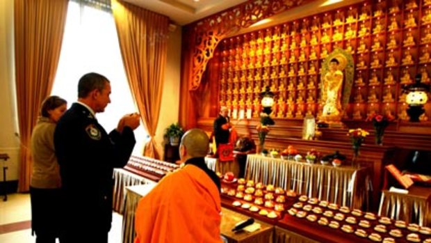 Letting go...Inspector Peter Fox at the funeral he arranged at the Nan Tien Buddhist Temple near Wollongong for a mother and her two children who were murdered.