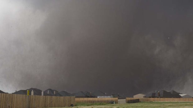 A tornado moves past homes in Moore, Oklahoma on Monday, May 20, 2013.