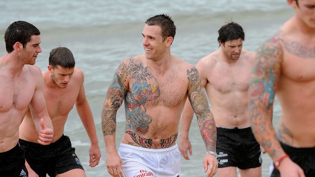 Main man: Brownlow medallist Dane Swan with his Collingwood teammates at the beach yesterday.