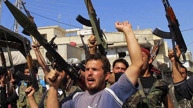 Members of the Free Syrian Army chant slogans against Syrian President Bashar al-Assad.