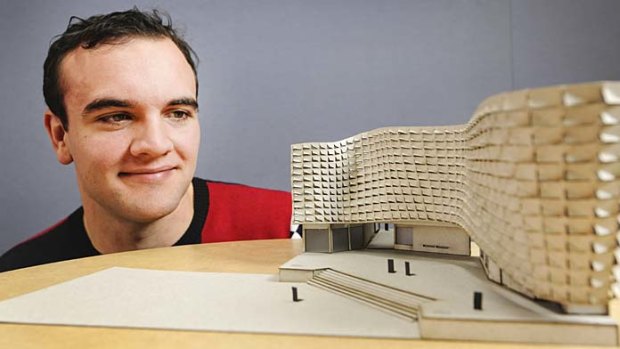 QUT architect student Alex Dickinson with his flood-proof building design.
