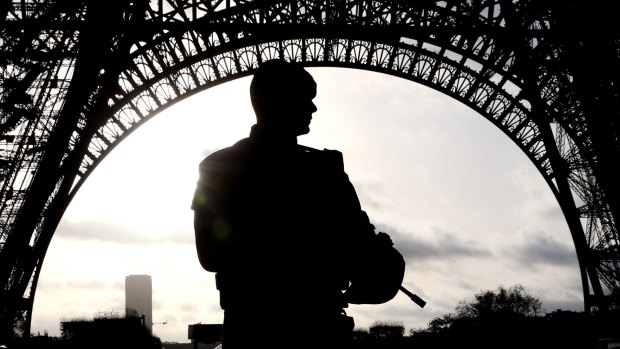 Armed military patrol the Eiffel Tower Paris France.