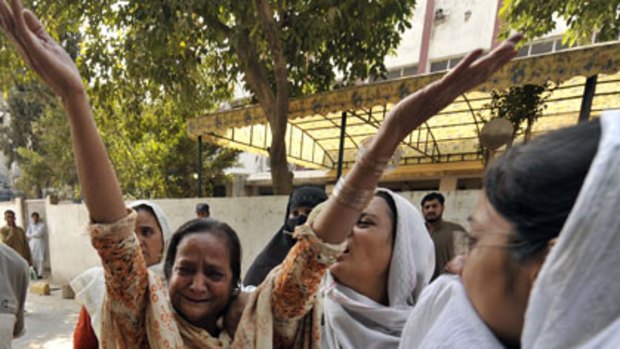 Dozens killed ... women outside a Rawalpindi hospital react to the news of a family member’s  death in the bomb blast.