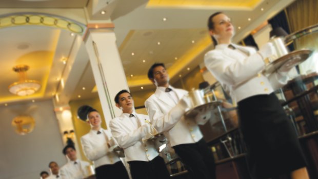 At 3.30pm on the dot, a bevy of white-gloved and white-jacketed waiters arrive to present the high tea.