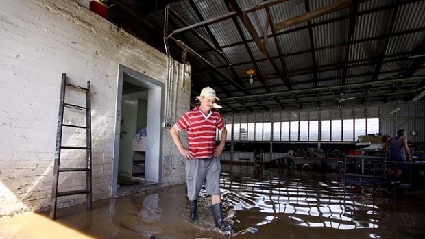 Martin Sangster from Ipswich Automatic Transmission surveys the damage to his shop on Brisbane Street, Ipswich. Flood water from the rising Bremer River caused damage again to this Ipswich business.