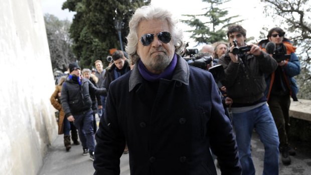 A rising star in Italian politics, former comedian Beppe Grillo leaves after casting his vote at a polling station in Genoa.