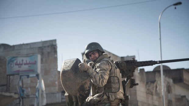 A Turkish soldier on a tank is pictured in the northern Syrian town of Kobane as he returns from a military operation inside Syria.