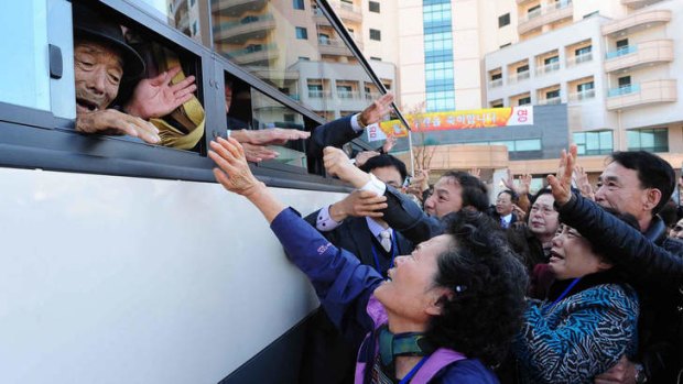 Heartbreak: South Koreans say goodbye to North Korean relatives on a bus following a three-day family reunion at the Mount Kumgang resort in 2010.