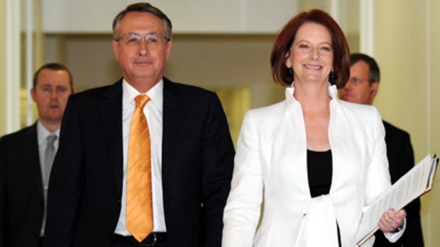 Winners are grinners ... Wayne Swan and Julia Gillard arrive to deliver their victory speech.