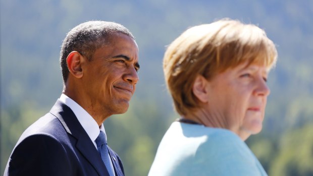 Strained relations: US President Barack Obama watches Germany's Chancellor Angela Merkel as she delivers her speech at a breakfast meeting in Kruen near Garmisch-Partenkirchen, southern Germany, last week.