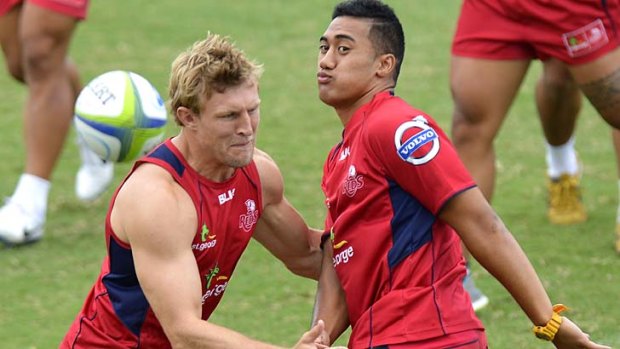 Jamie-Jerry Taulagi gets a ball away during a Queensland Reds Super Rugby training session.