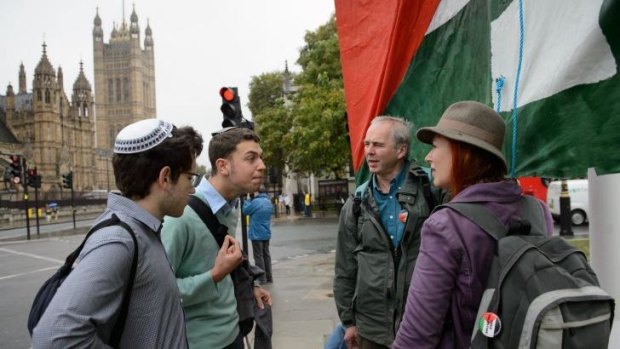 Different sides: Young Jewish men argue with pro-Palestinian supporters before the vote in the British Parliament.
