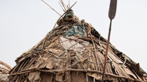 Ol Dassanech woman in front of her hut.